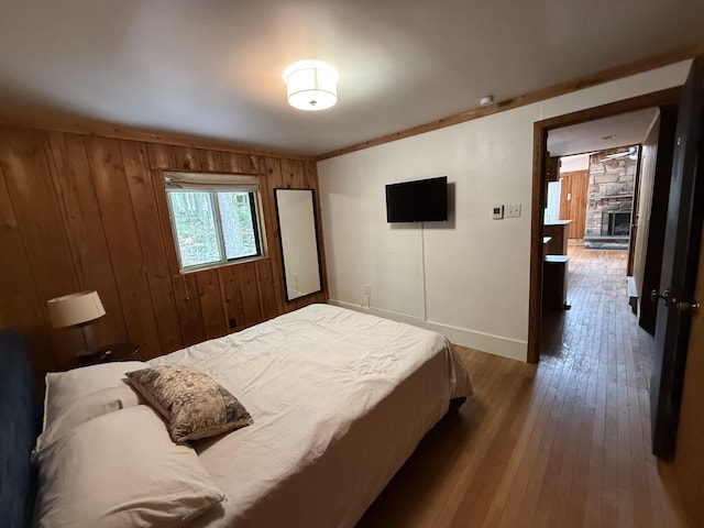 1827 Stag Run, Pocono Lake, PA 18347 - bedroom featuring hardwood / wood-style floors, wooden walls, and a fireplace