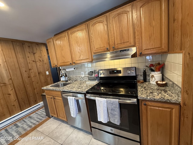 1827 Stag Run, Pocono Lake, PA 18347 - kitchen with appliances with stainless steel finishes, under cabinet range hood, backsplash, light stone counters, and wood walls