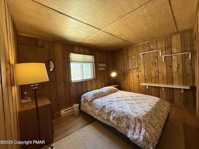 1827 Stag Run, Pocono Lake, PA 18347 - bedroom featuring baseboard heating, wood finished floors, and wooden walls