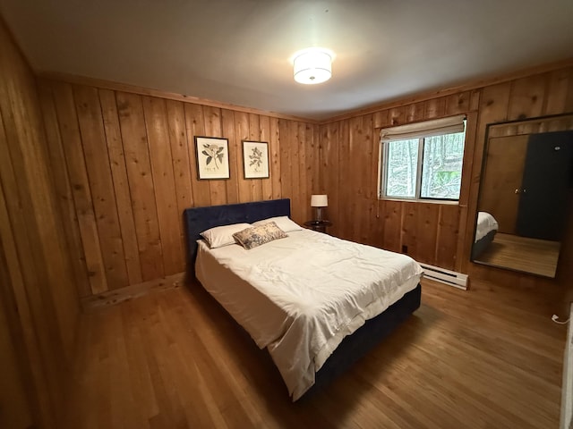 1827 Stag Run, Pocono Lake, PA 18347 - bedroom with a baseboard radiator, wood finished floors, and wooden walls