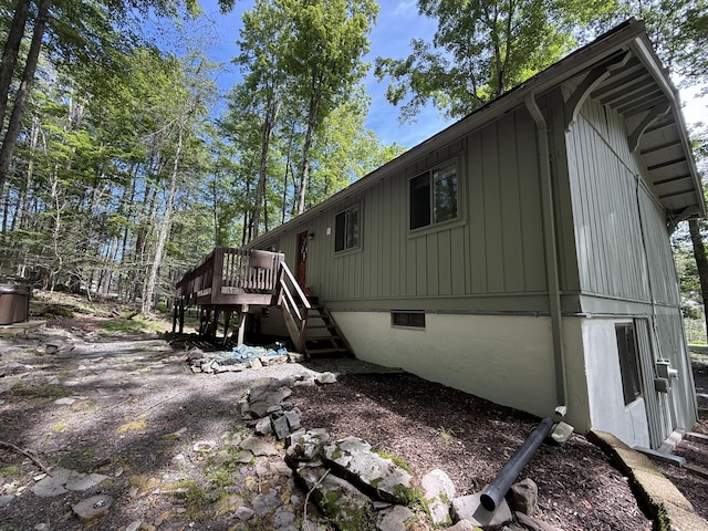 1827 Stag Run, Pocono Lake, PA 18347 - rear view of property featuring stairway, a deck, and board and batten siding