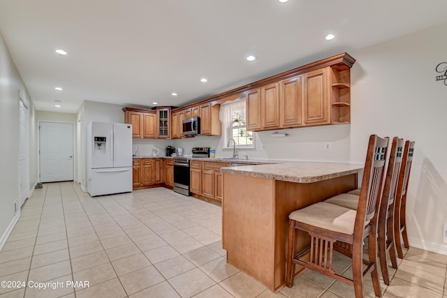 kitchen with appliances with stainless steel finishes, recessed lighting, a peninsula, and open shelves