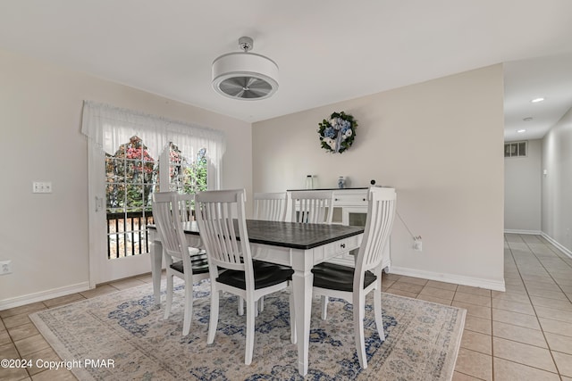 dining space featuring tile patterned flooring, visible vents, and baseboards