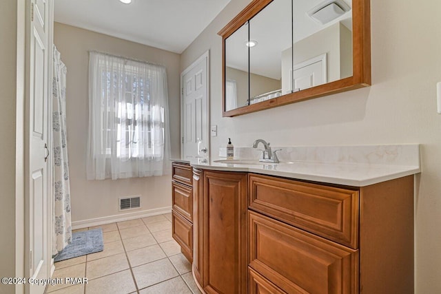 bathroom featuring tile patterned flooring, visible vents, baseboards, and vanity