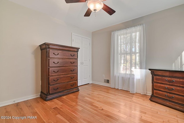 bedroom featuring light wood-type flooring, ceiling fan, and baseboards