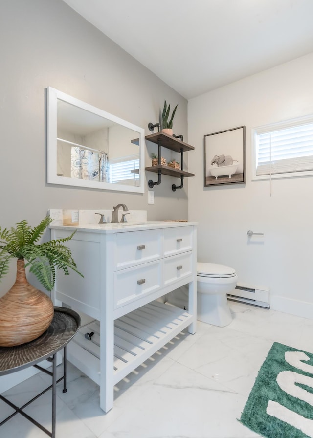 full bath featuring marble finish floor, toilet, vanity, and baseboard heating