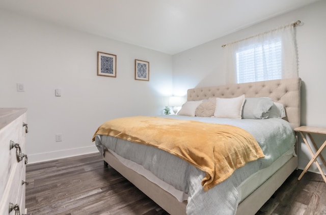 bedroom with dark wood-style floors and baseboards