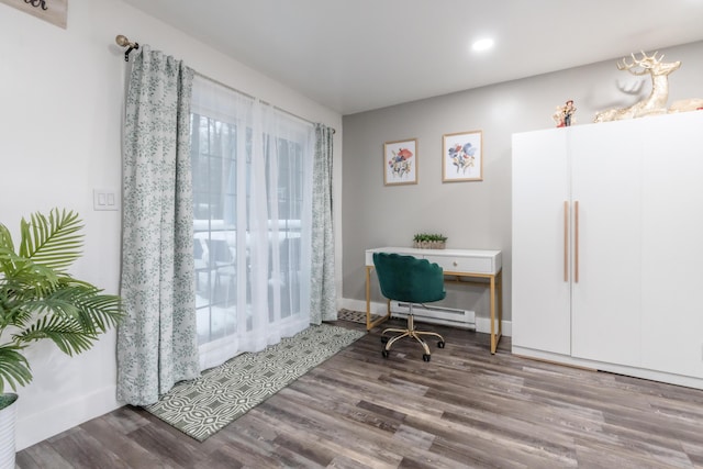 office area featuring baseboards, baseboard heating, and wood finished floors