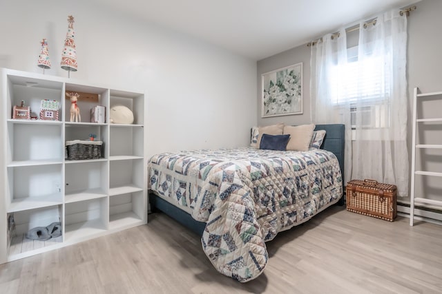 bedroom featuring cooling unit and wood finished floors