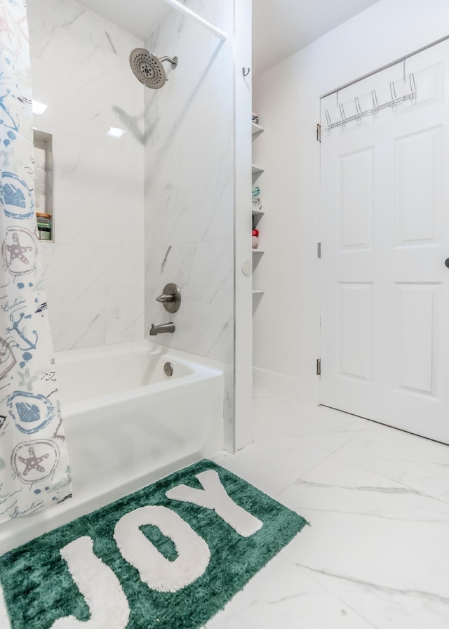 full bath with shower / bath combo and marble finish floor