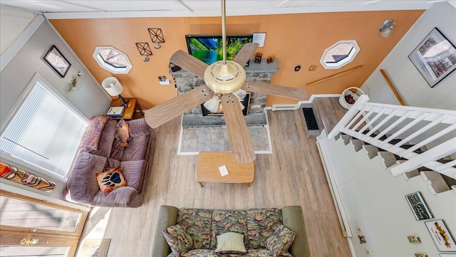 living area with wood finished floors and stairway