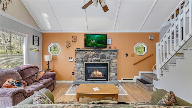 living room featuring ceiling fan, stairs, wood finished floors, lofted ceiling, and a baseboard radiator