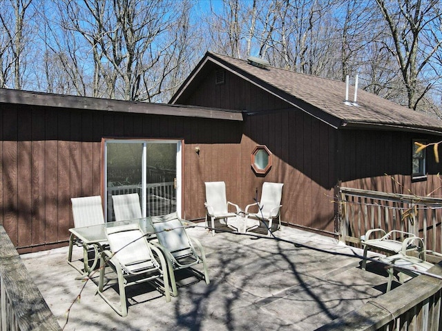 back of house featuring roof with shingles, fence, and a patio