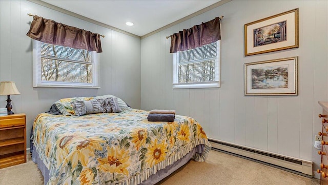 bedroom featuring crown molding, a baseboard heating unit, and carpet flooring