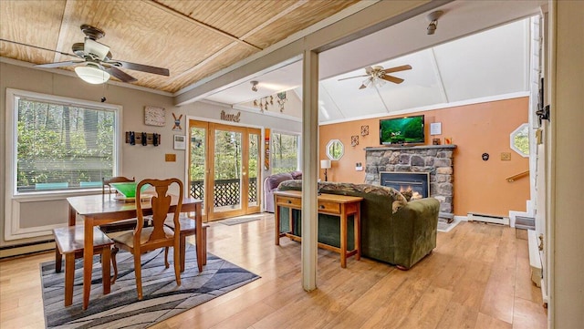 dining area featuring ceiling fan, lofted ceiling with beams, a baseboard heating unit, and light wood finished floors