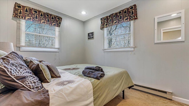 bedroom featuring carpet flooring, a baseboard heating unit, multiple windows, and ornamental molding