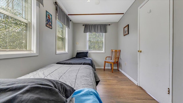 bedroom featuring baseboards and wood finished floors