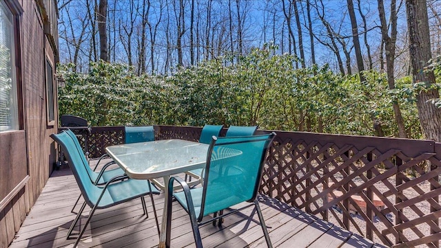 wooden deck featuring outdoor dining space