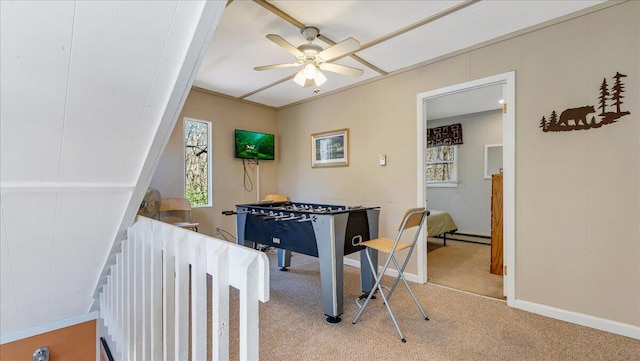recreation room with baseboards, ceiling fan, and light carpet