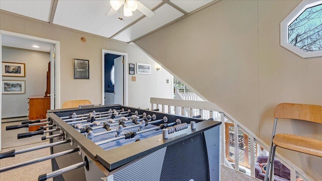recreation room with a ceiling fan, a baseboard heating unit, and lofted ceiling