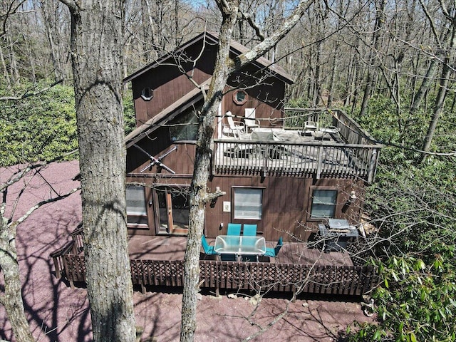 back of house featuring a forest view