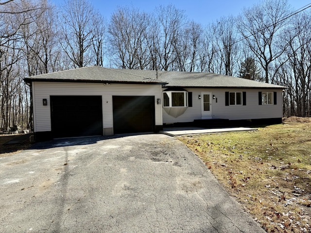 ranch-style house featuring driveway and an attached garage