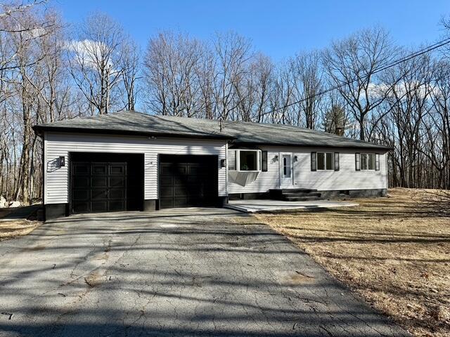 ranch-style house with a garage and driveway