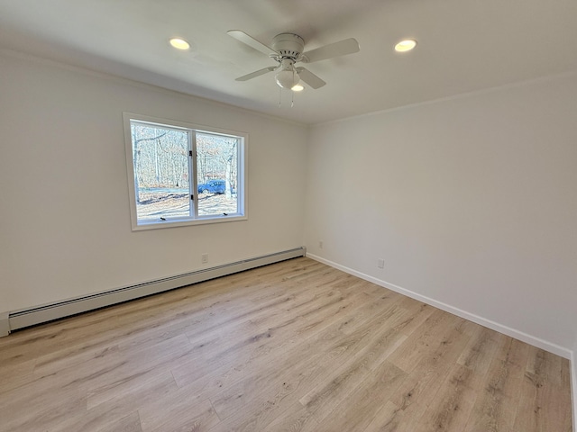 empty room featuring light wood-style floors, recessed lighting, baseboards, and baseboard heating