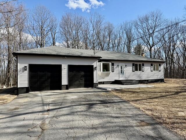 ranch-style house with driveway and an attached garage