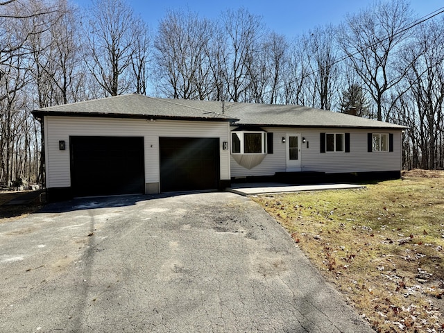 ranch-style house with an attached garage and driveway