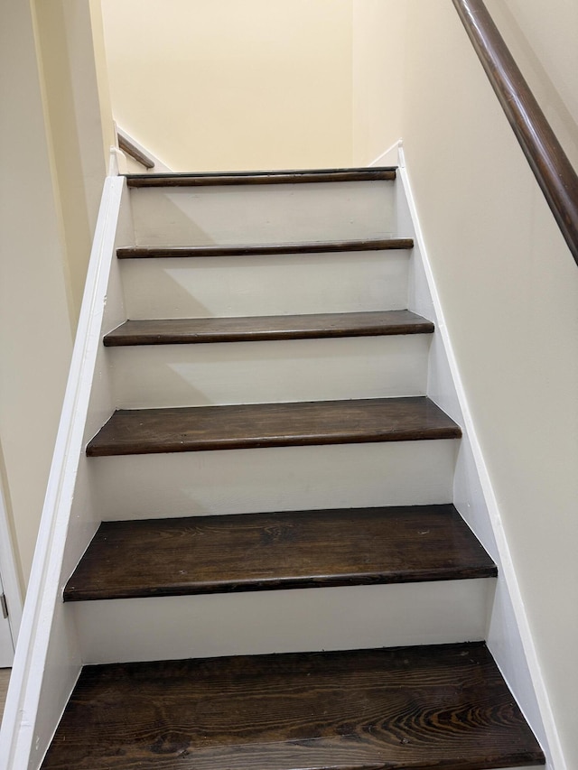 stairway featuring wood finished floors