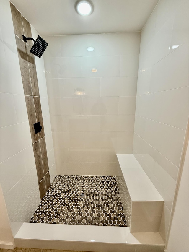 bathroom with a tile shower