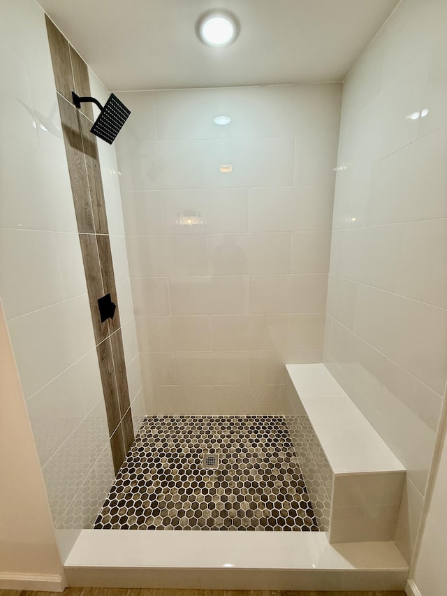 full bath with tiled shower