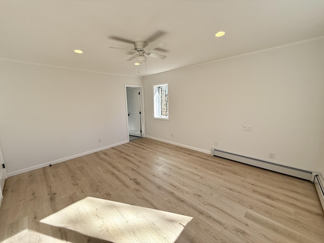 empty room with light wood-type flooring, baseboards, a baseboard heating unit, and crown molding