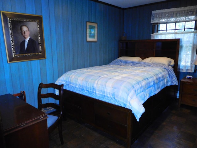 bedroom featuring wooden walls