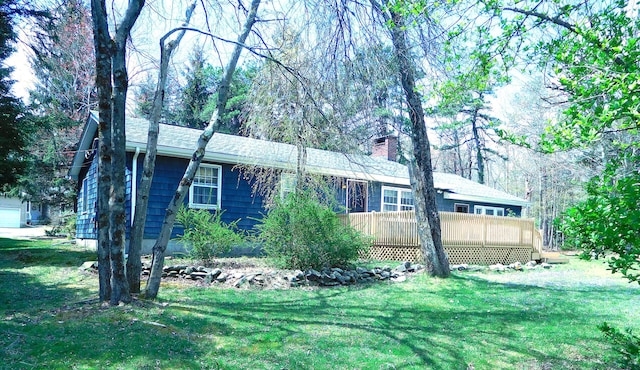 view of front of property featuring a front lawn and a chimney