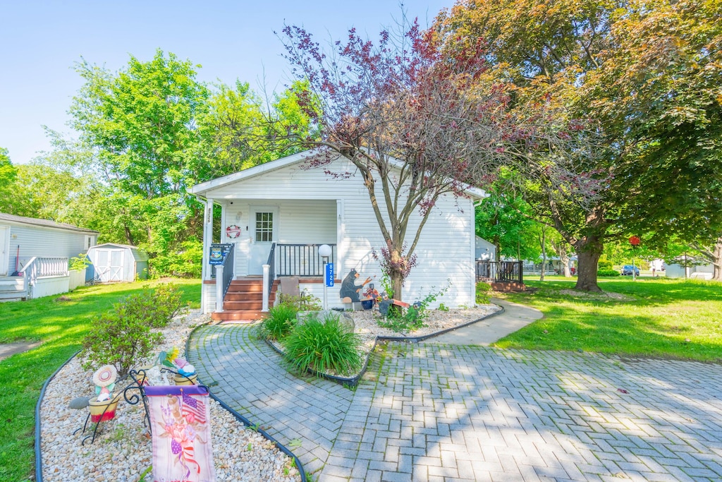 8726 Breinig Run Cir, Breinigsville, PA 18031 - view of front of home with a storage shed, a porch, and a front lawn