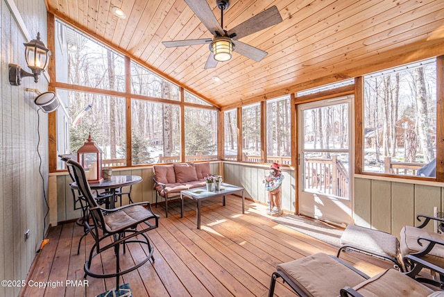 sunroom / solarium with wood ceiling, ceiling fan, and vaulted ceiling