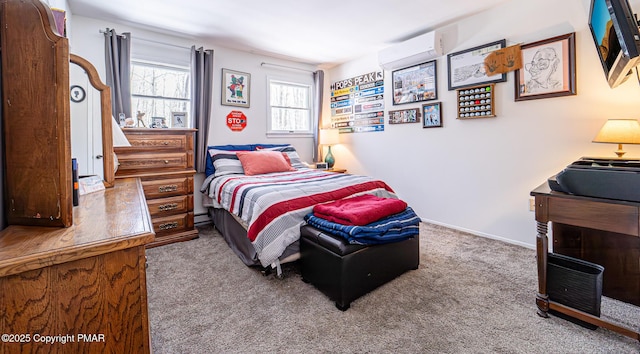 carpeted bedroom featuring baseboards and a wall mounted air conditioner