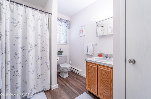 bathroom with toilet, wood finished floors, a baseboard radiator, baseboards, and vanity