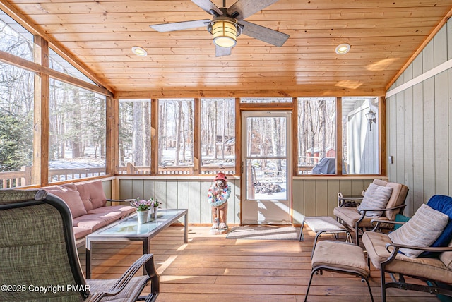 sunroom featuring wooden ceiling, a ceiling fan, and lofted ceiling