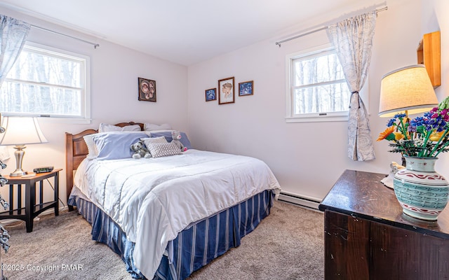 bedroom with a baseboard radiator and light carpet