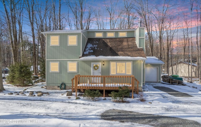 view of front property featuring a wooden deck and a garage