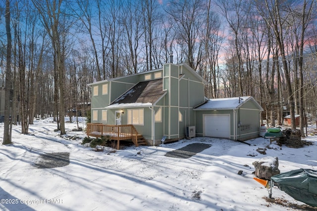 view of front of house with a garage and a wooden deck