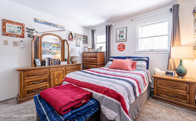 bedroom featuring baseboards and light colored carpet