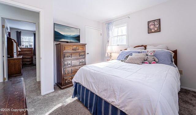 carpeted bedroom featuring baseboards