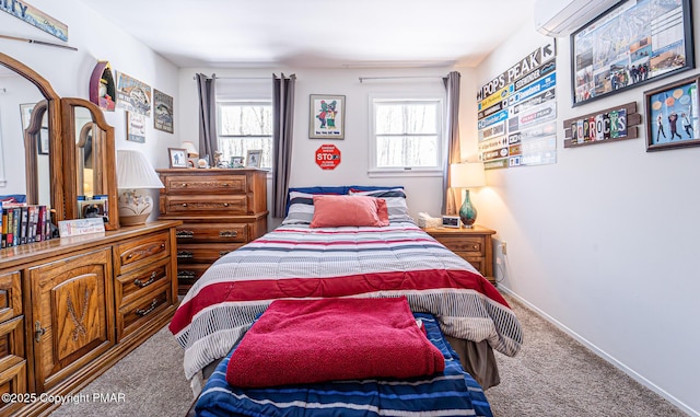 bedroom featuring an AC wall unit, multiple windows, carpet flooring, and baseboards