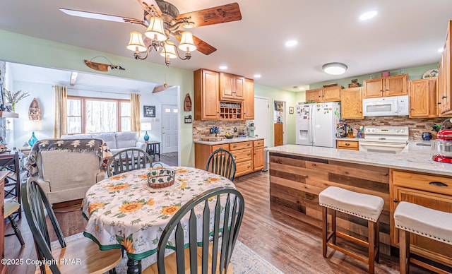 dining room with wood finished floors, recessed lighting, and a ceiling fan