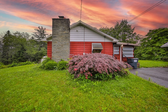 60 Maple Dr, Palmerton, PA 18071 - property exterior at dusk featuring a chimney and a lawn