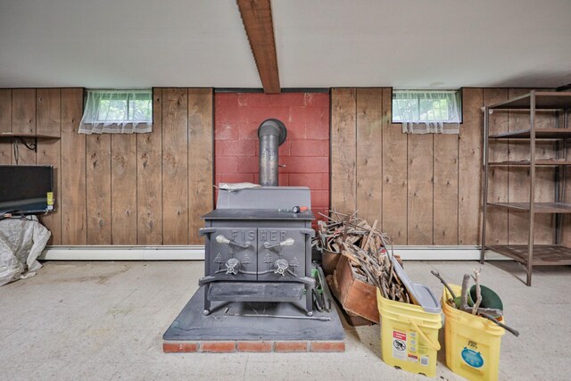 60 Maple Dr, Palmerton, PA 18071 - living room featuring a wood stove, plenty of natural light, wood walls, and a baseboard radiator